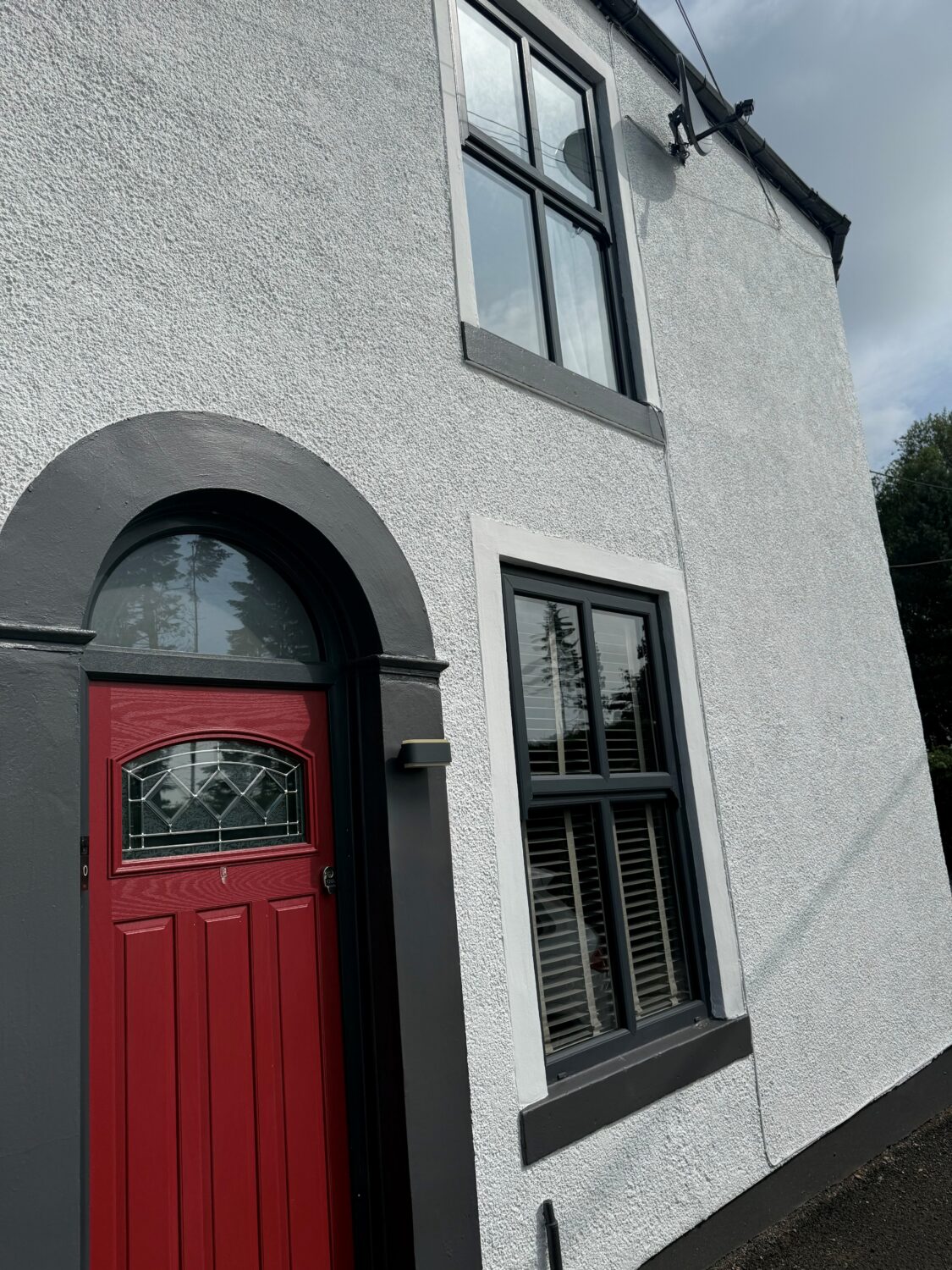 A house painted with Smokey White masonry paint