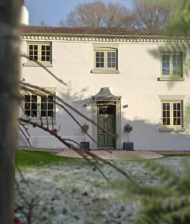 A newly painted white home in snowy conditions