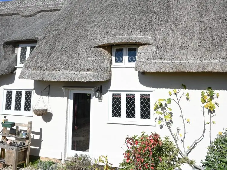 A traditional house painted with Mushroom masonry paint
