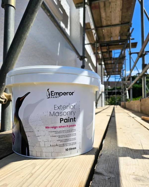 A tub of Emperor Masonry Paint on scaffolding