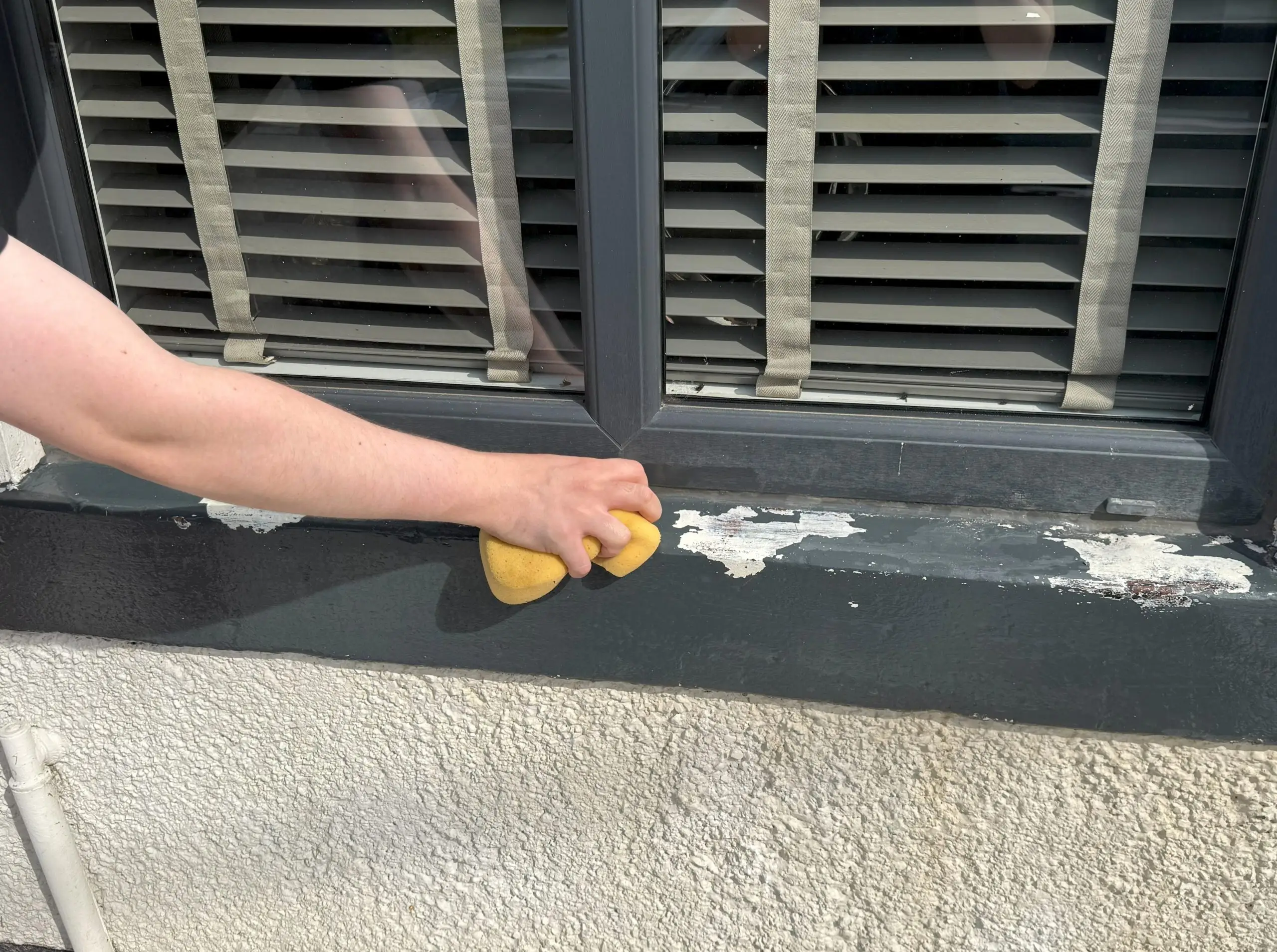 A window sill being cleaned before painting