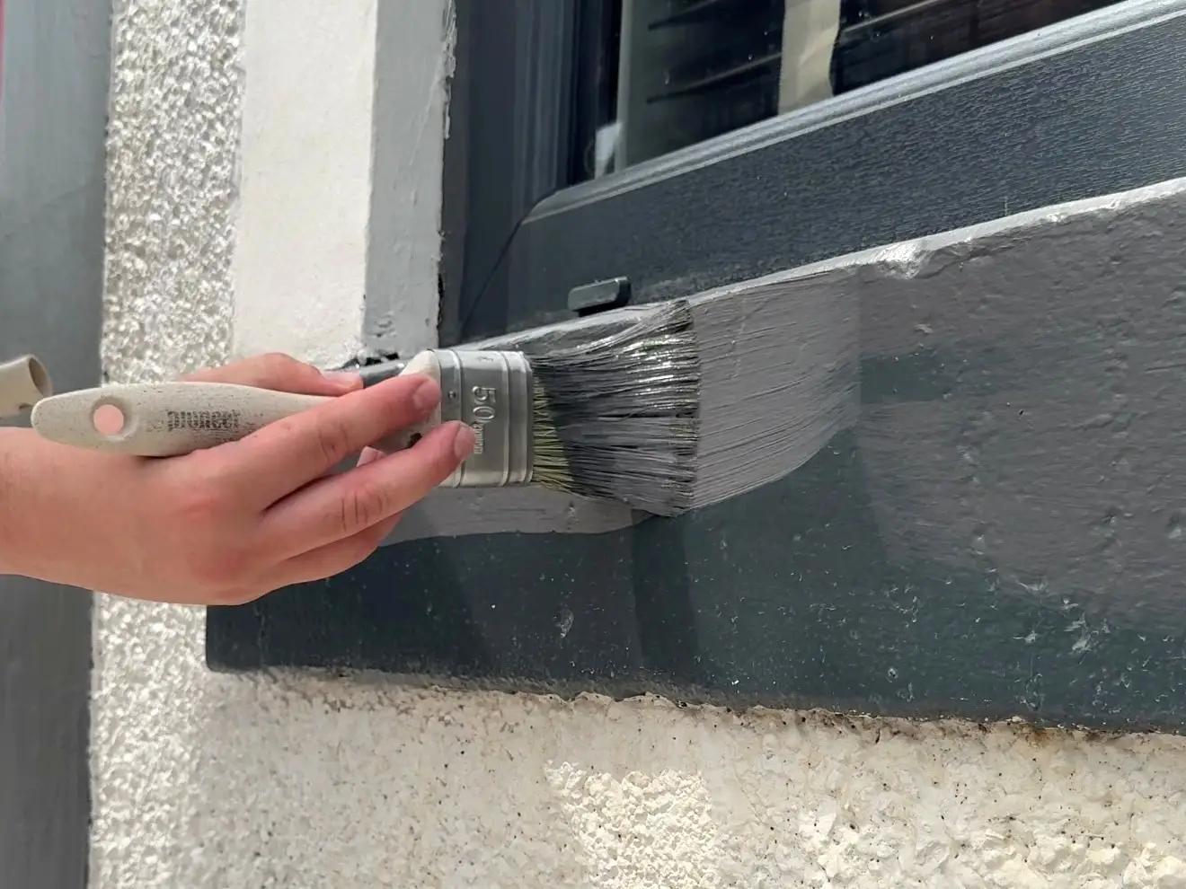 Applying Dark paint to a wall