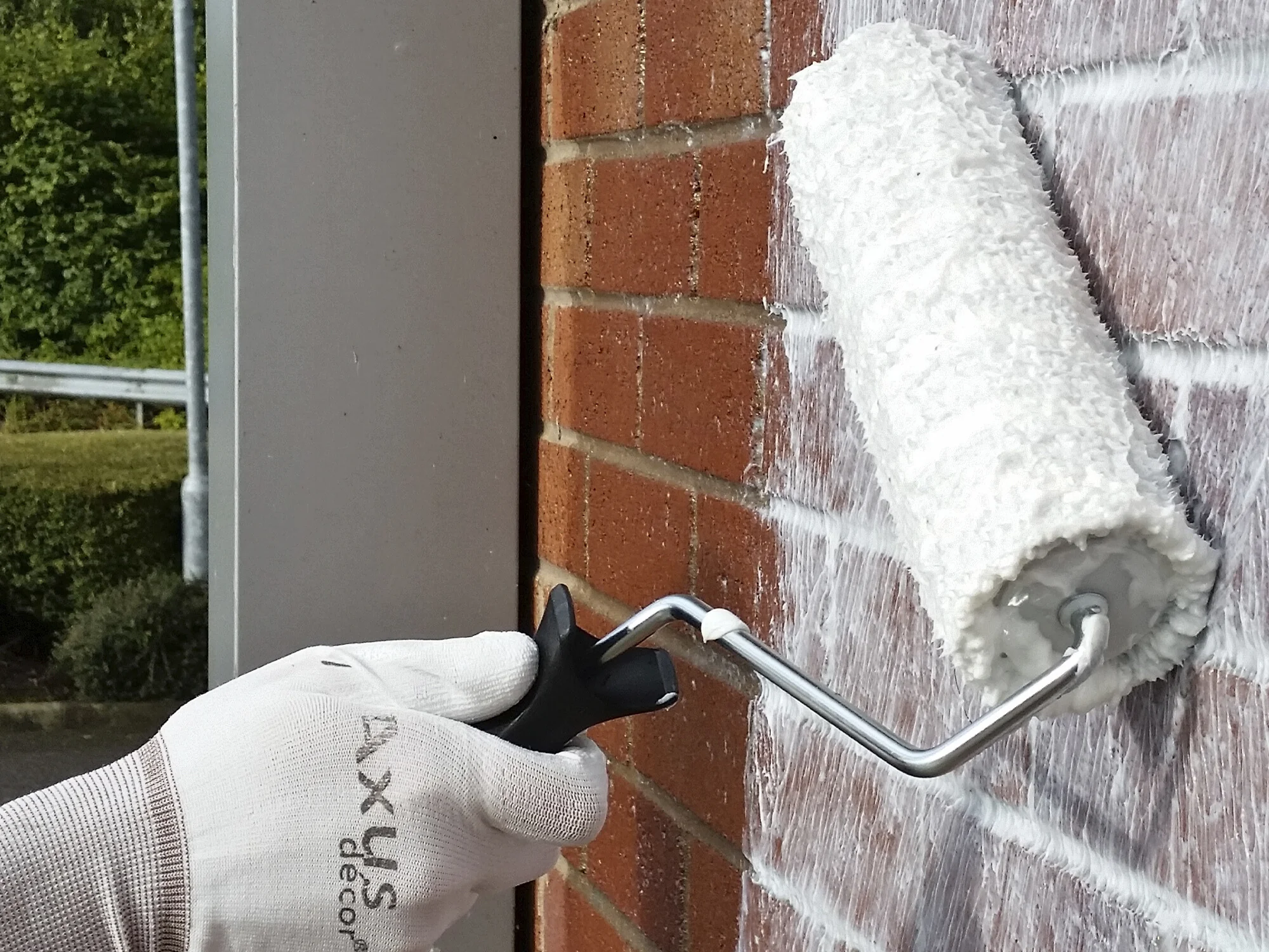 Applying penetrating damp treatments to wall