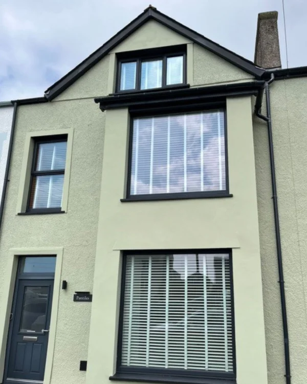 David Betts using green masonry paint