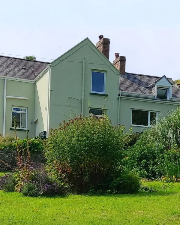 David Willis using green masonry paint